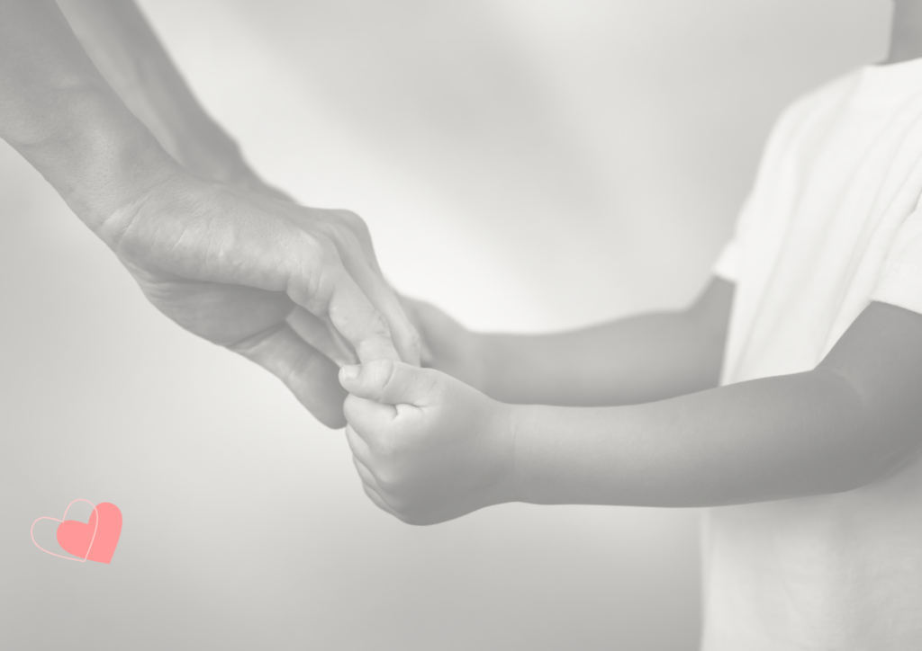 A parent gently holding a child's hand, symbolizing trust, connection, and the healing journey of rebuilding relationships through mindful parenting