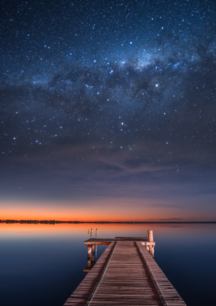 endless water under a star-filled sky, evoking a sense of wonder, vastness, and the limitless possibilities that come with letting go